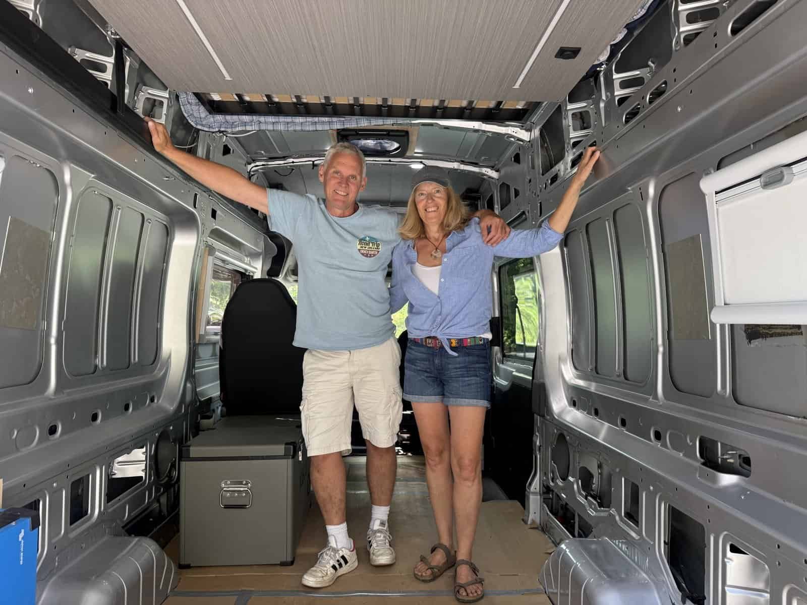 Smiling inside a van, enjoying outdoor adventure and nature, with open space and sunlight, emphasizing travel, freedom, and outdoor lifestyle.